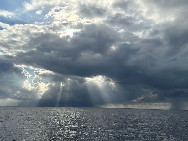 skirting storm clouds- sun peaking through