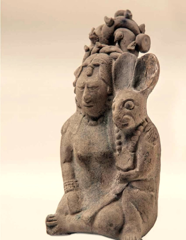 A ceramic artifact depicts Ixchel with a rabbit, representative of the moon in Mayan culture. 